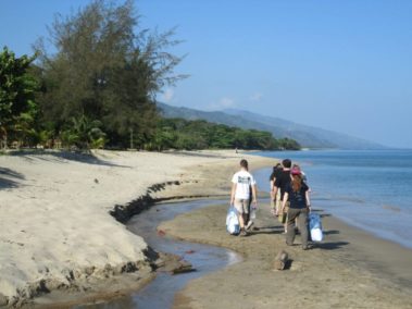 Students clearing trash from a beach