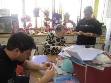 Students crafting with an old woman