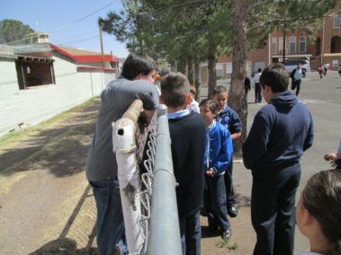 Students standing at a fence