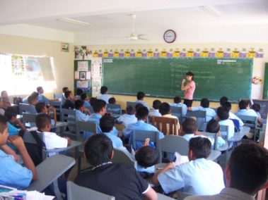 Student teaching a large class of children