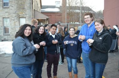 Group of students holding small candles and rosaries