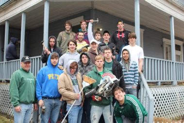 Group of volunteers outside of a house