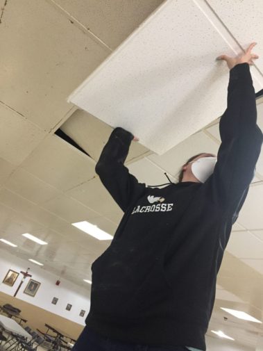 Student working on ceiling