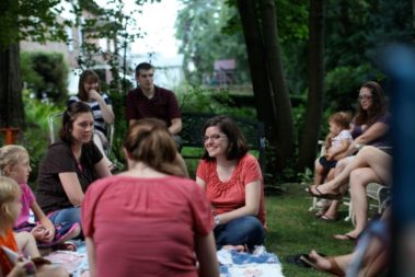 Students picnicking with children