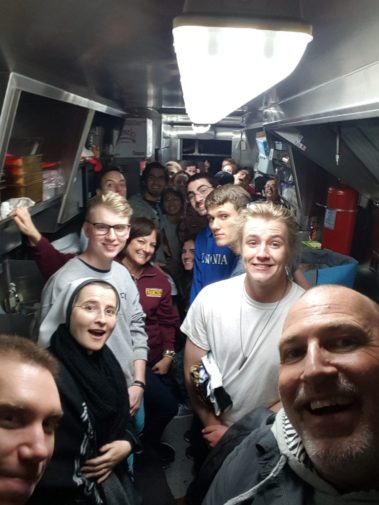 Students standing in a long kitchen