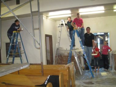Students painting a house