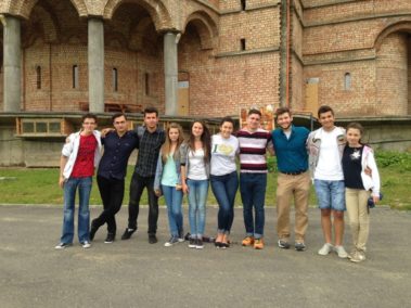 Group of Students standing outside a large building