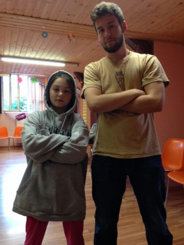 Student standing with a child