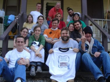 Group of volunteers on the steps to a house