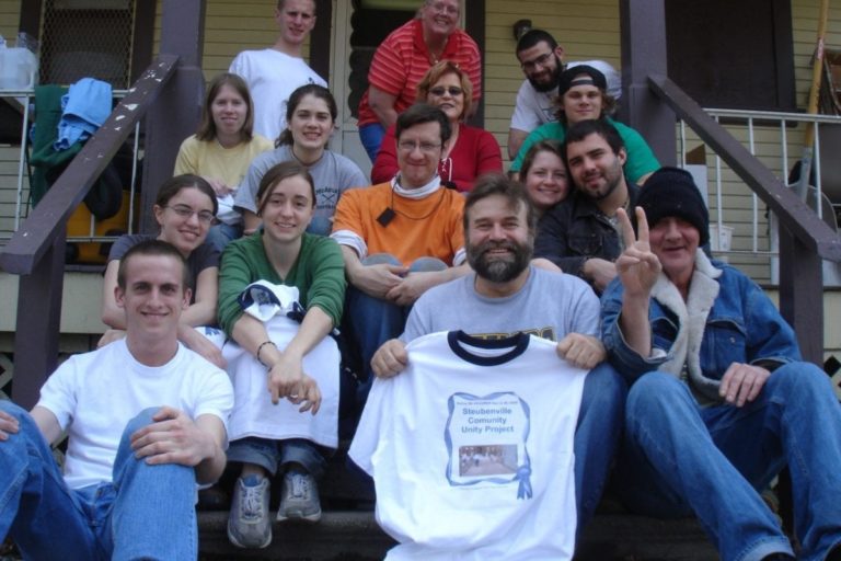 Group of volunteers on the steps to a house Group of volunteers on the steps to a house