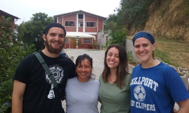 Students in front of a home Students in front of a home