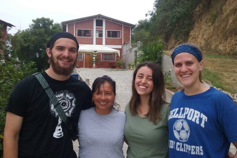 Students in front of a home Students in front of a home